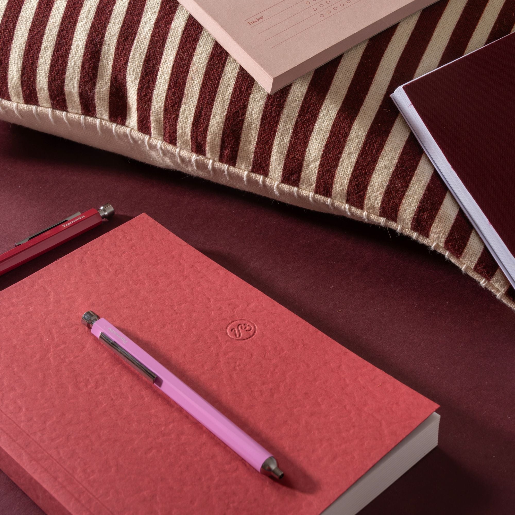 flat lay striped pillow red notebook