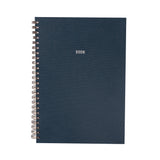 Navy blue planner with '2026' printed on it, featuring a gold spiral binding.