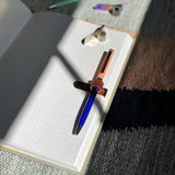 pen clipped to notebook